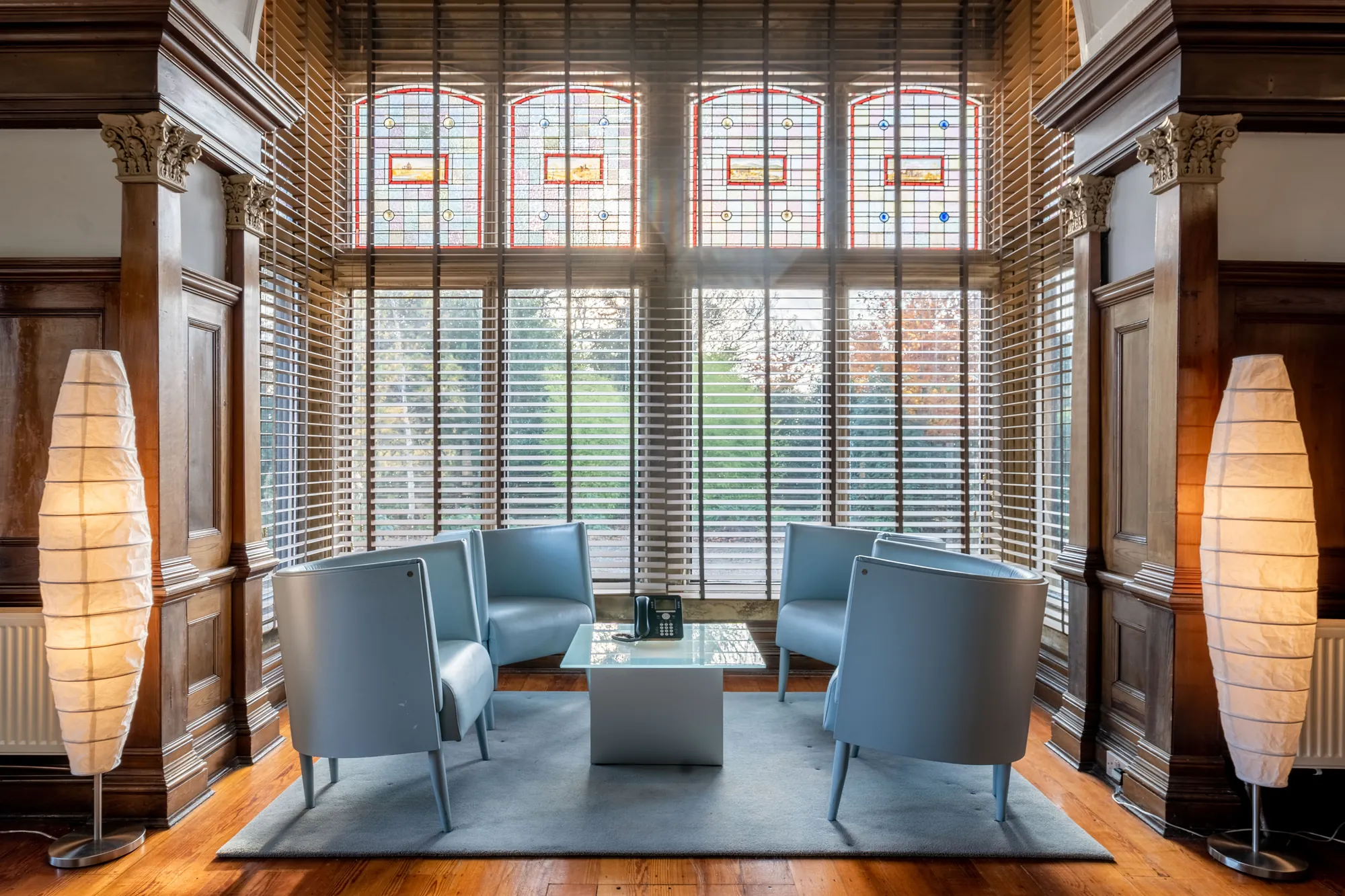 The wood-panelled interior of Bilton Court with original stained-glass windows