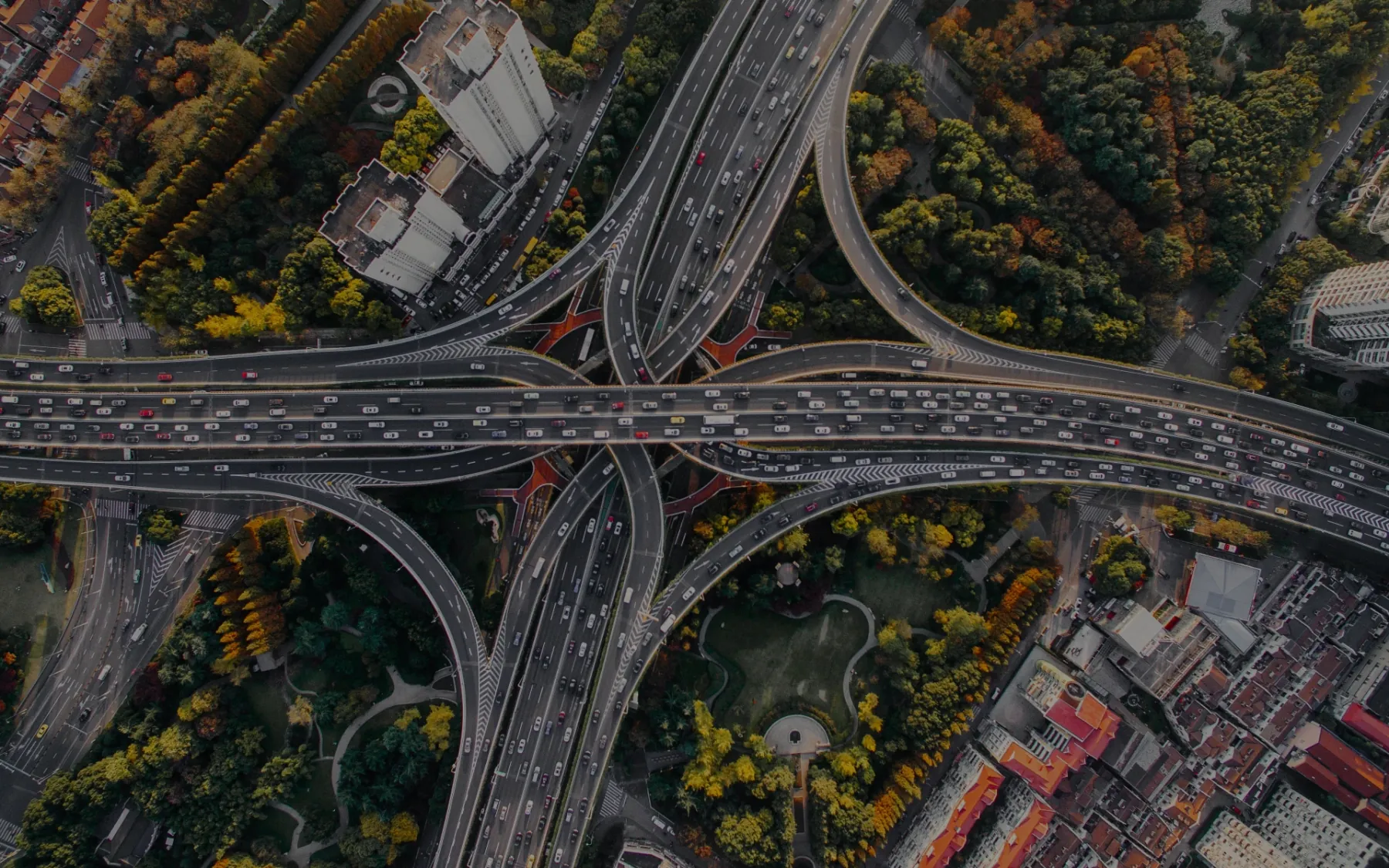 Aerial view of a vast motorway interchange busy with traffic